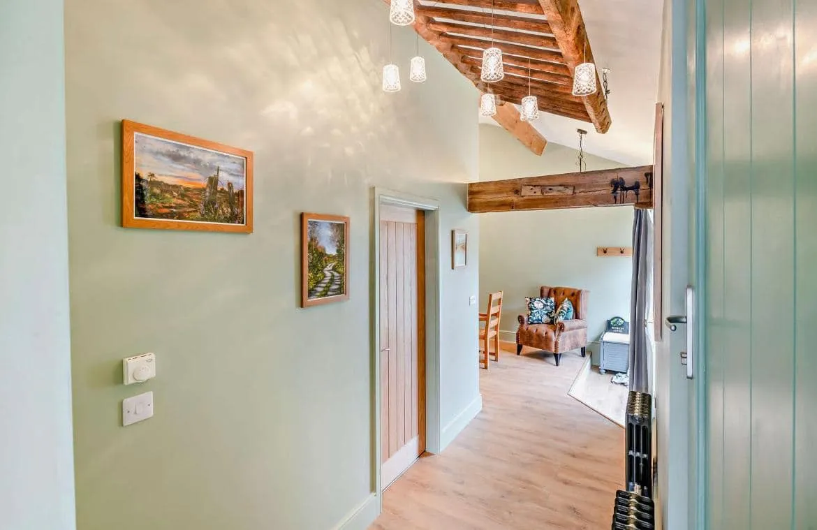 A hallway leading to a living room and dining room.